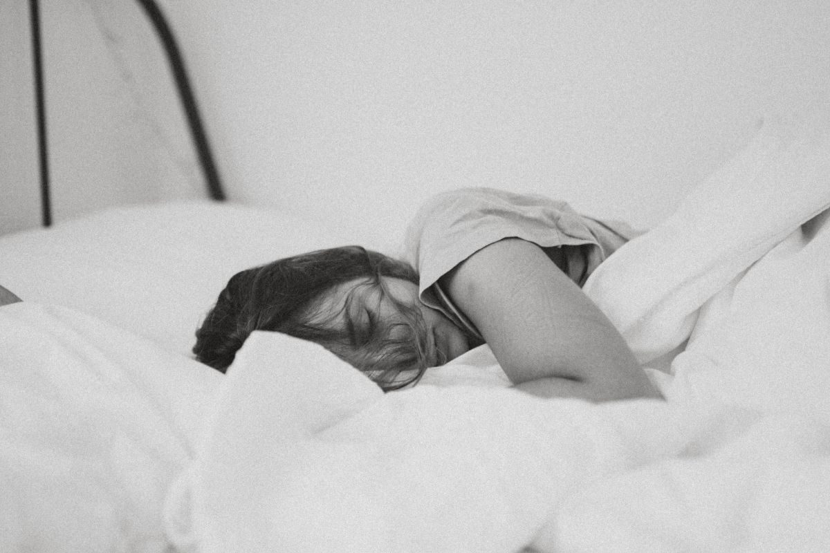 woman sleeping white duvet